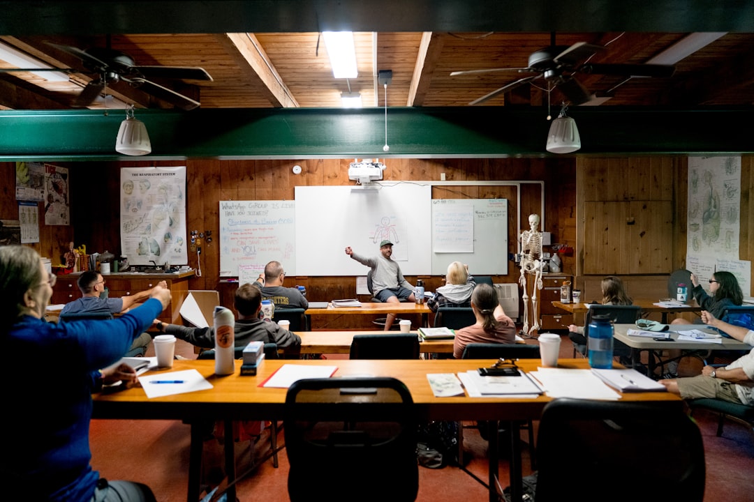 Instructor leads class in a room with whiteboard.